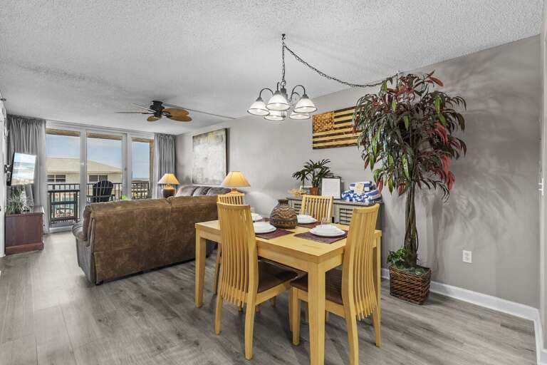 Versatile living and dining combo comfortably seats four, ideal for shared meals and relaxation.