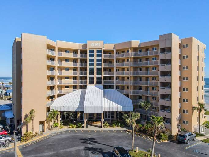 Elevate your experience with a bird's-eye view of our stunning oceanfront building and its surrounding beauty.