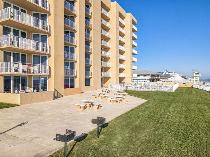 Welcome home! Admire the exterior of our condo building, a beautiful seaside retreat for your vacation.