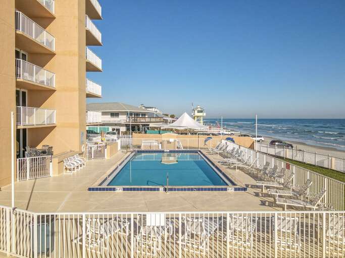 Pool area with lounge chairs.
