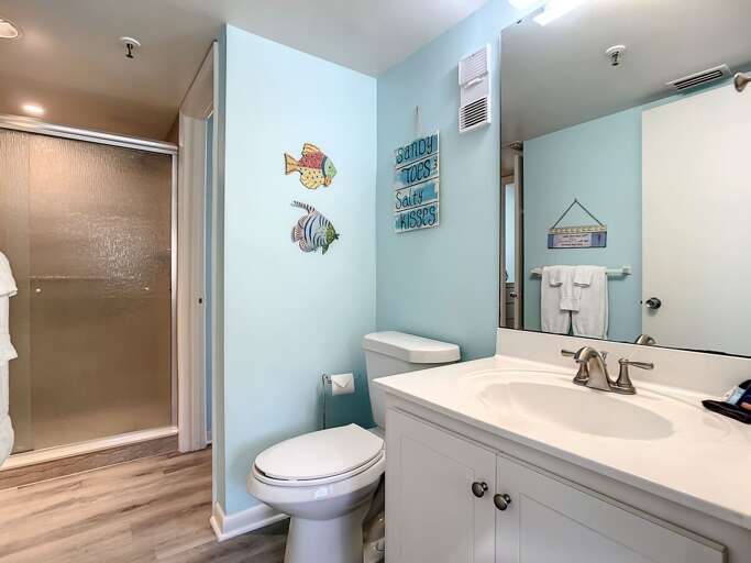 Vanity with storage and toilet.