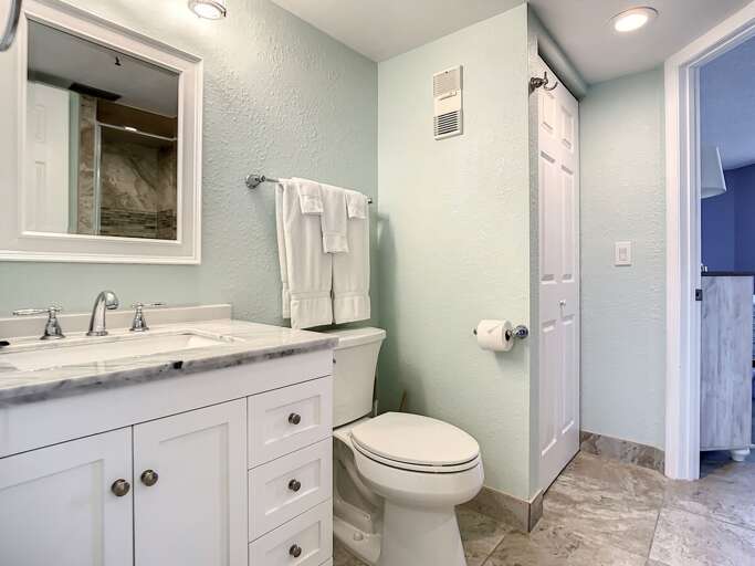 Vanity with storage. Toilet. Closet for extra storage.