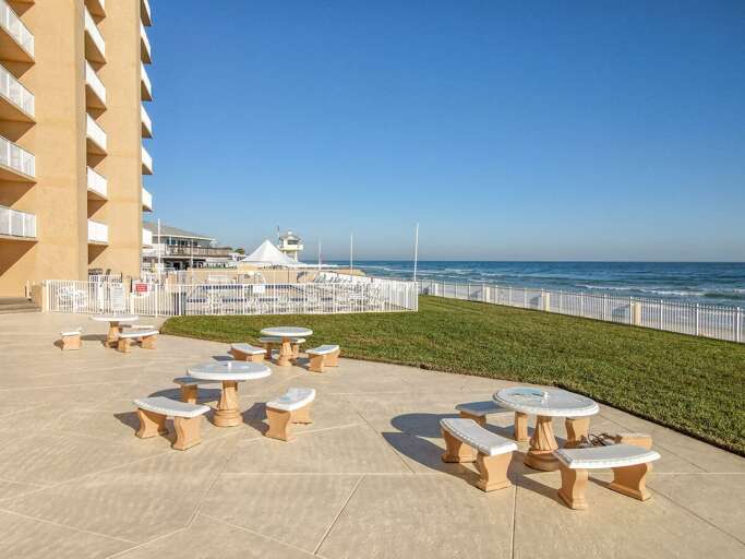 4 picnic tables over looking the beach.