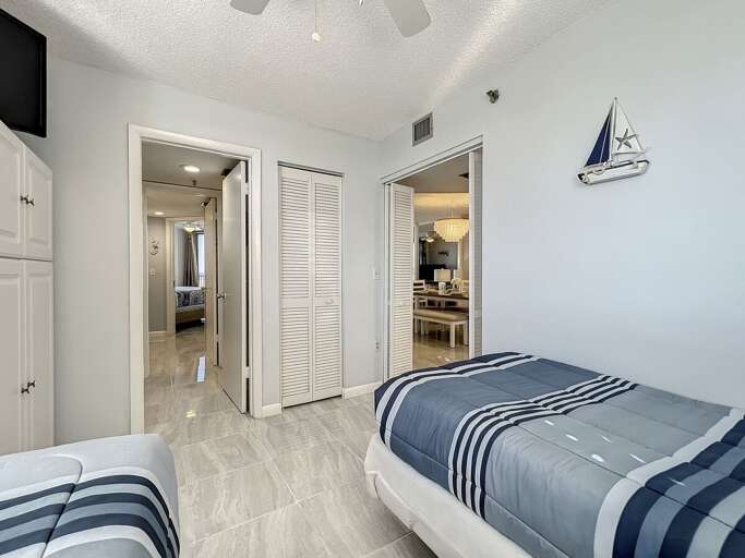 Flat screen tv in bedroom. Access to bathroom and foyer.