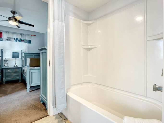 Shower tub combo. Access to guest bedroom.