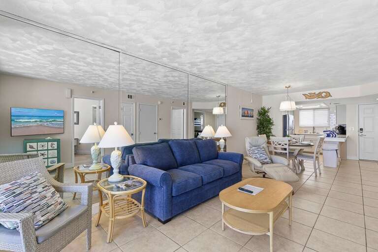 Enjoy a comfortable beach stay in this spacious open-concept living area featuring cozy seating,