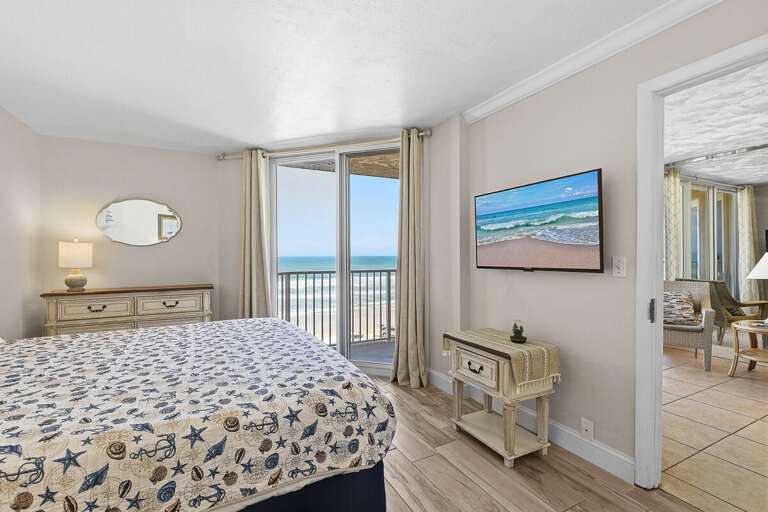 Enjoy a relaxing beach stay in this oceanfront bedroom featuring a cozy bed, TV, and private balcony with stunning views. Fall asleep to the sound of waves and wake up to beautiful coastal scenery.
