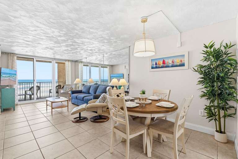 This spacious beach stay features an open living and dining area with coastal décor, comfortable