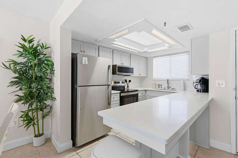 This beach stay features a bright, fully equipped kitchen with modern appliances and a spacious