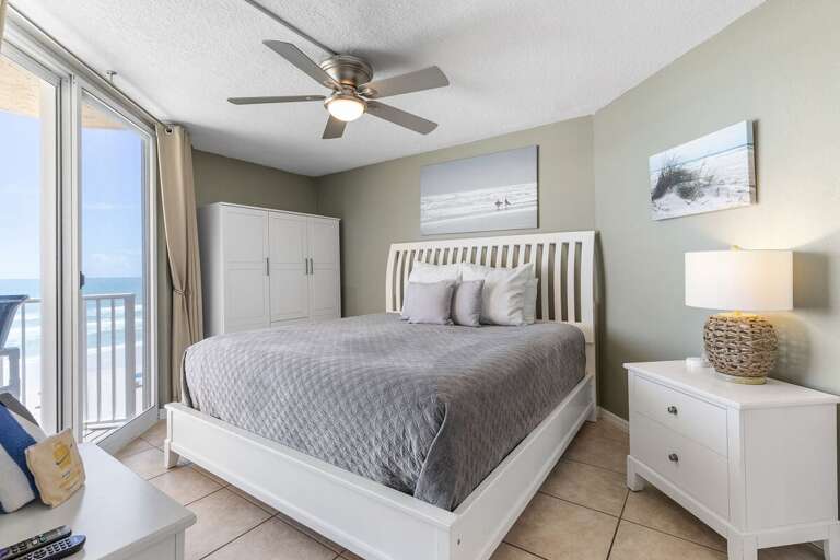 Beachside Bedroom With Blue Hues And Balcony View