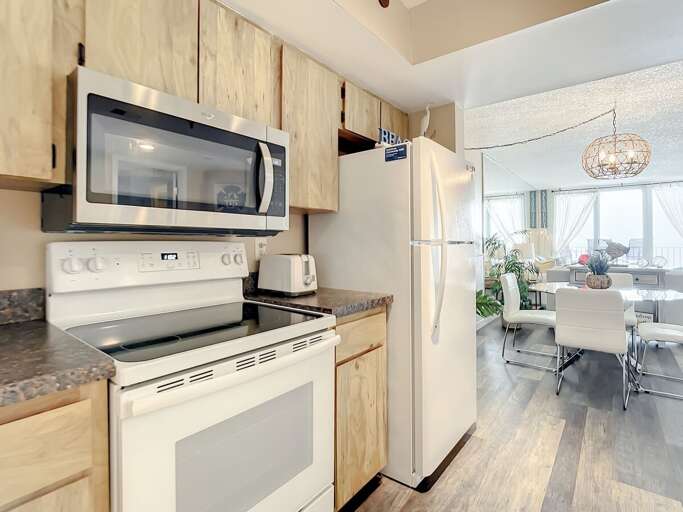 Flat top stove, microwave and full size fridge.