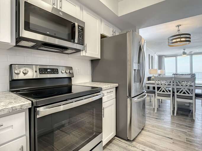 Flat top stove with microwave above. Full size fridge.