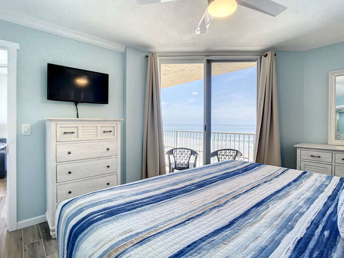 Mounted TV in bedroom. Access to balcony.