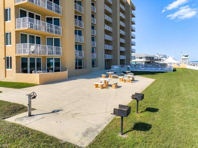 5 picnic tables with 2 charcoal grills available.