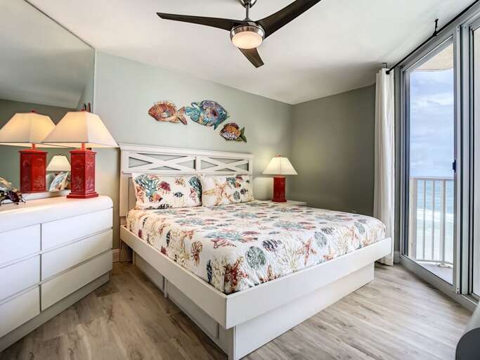 Wake up to ocean views in this master bedroom featuring coastal-inspired accents and ample natural light.