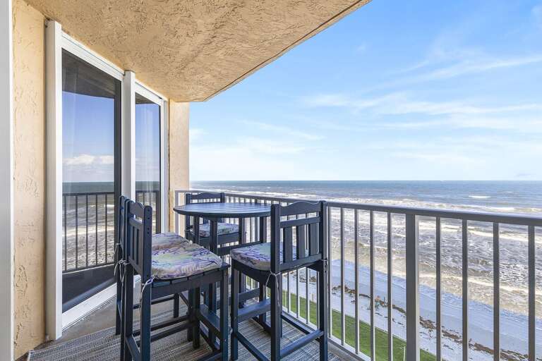 Relax with panoramic ocean views from a cozy, private balcony featuring stylish seating and serene ambiance. Relax with panoramic ocean views from a cozy, private balcony featuring stylish seating and serene ambiance.
