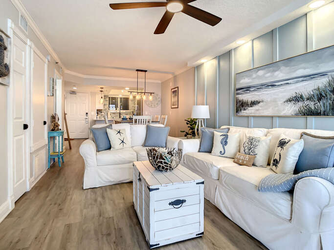 Cozy couches that seat 5. Ceiling fan above.