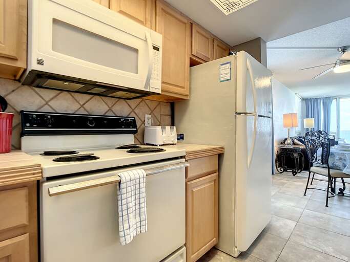 Stove with microwave above and full size fridge. Stove with microwave above and full size fridge.