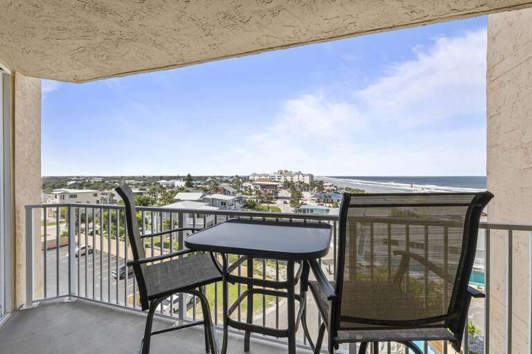 A comfortable patio table and chairs invite you to sit and enjoy the expansive view of rooftops and winding roads leading to the ocean in the distance. A comfortable patio table and chairs invite you to sit and enjoy the expansive view of rooftops and winding roads leading to the ocean in the distance.