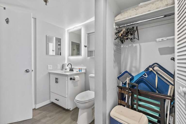 This modern bathroom features a sleek vanity, illuminated mirror, and contemporary fixtures. This modern bathroom features a sleek vanity, illuminated mirror, and contemporary fixtures.