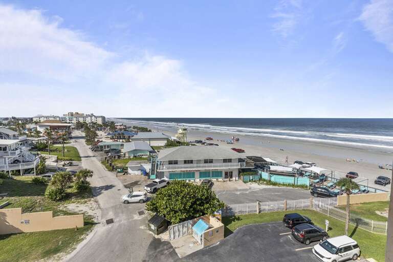 This picturesque shot captures the essence of coastal living, featuring a vibrant beachside community and panoramic oceanfront views. This picturesque shot captures the essence of coastal living, featuring a vibrant beachside community and panoramic oceanfront views.