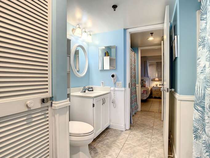 Walk in shower. Access to the guest bathroom.