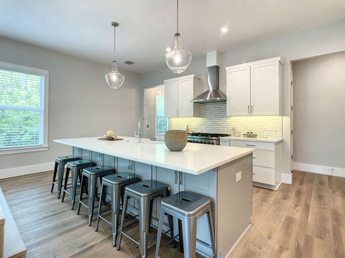 Our open kitchen with a sizable island, dining area, and breakfast bar is designed for both gourmet cooking and casual dining