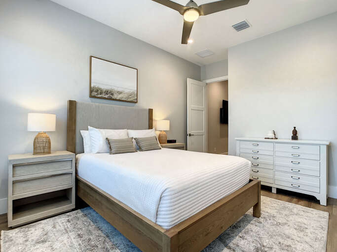 Relax in our spacious guest bedroom, complete with a queen bed, storage essentials, and a soothing ceiling fan.