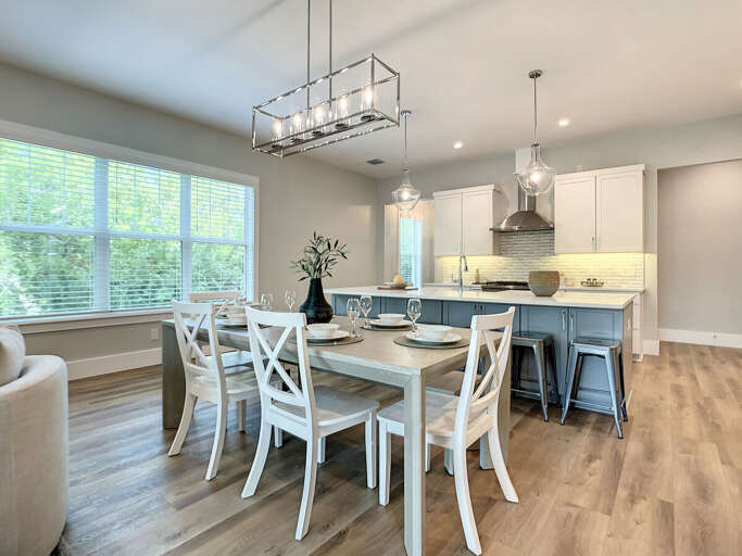 Our spacious kitchen boasts a large island, dining area, and breakfast bar, offering ample space for feasts and laughter.