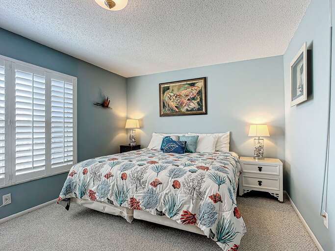 A tranquil bedroom with coastal decor, soft lighting, and a comfortable bed. A tranquil bedroom with coastal decor, soft lighting, and a comfortable bed.