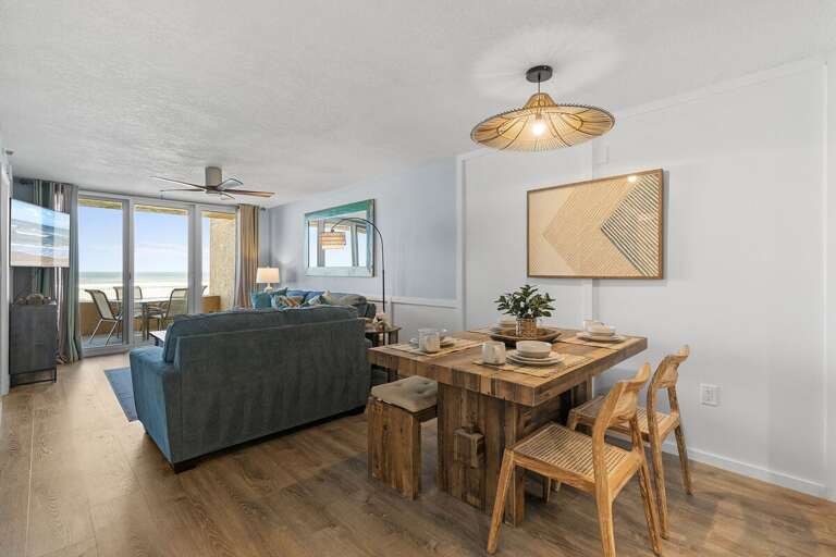 This bright and airy space features a rustic dining table, cozy living room, and large windows