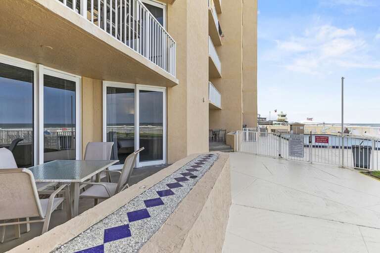 Enjoy this spacious patio with easy access to the pool and a stunning view of the ocean, perfect for relaxation or dining outdoors.