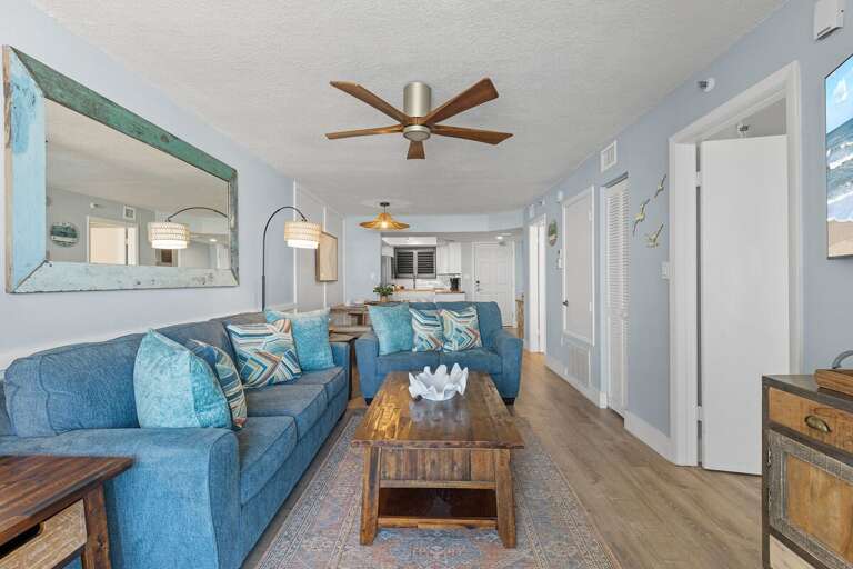 The open-concept design flows seamlessly into the dining area and modern kitchen, creating a perfect space for relaxation and entertaining.