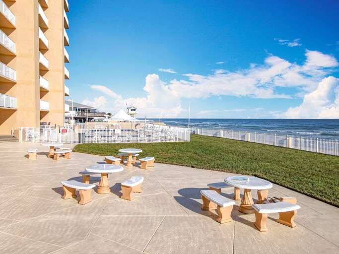 Relax and dine al fresco in this inviting picnic area, offering ocean views and a perfect space for outdoor gatherings by the beach.