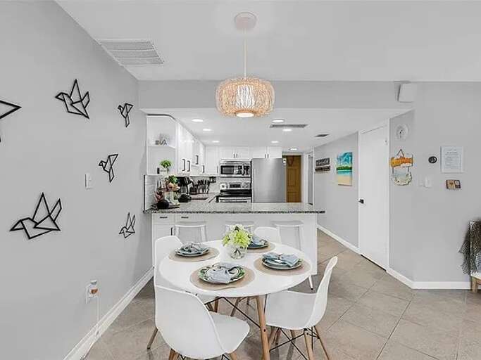 Chic and cozy setup for shared meals just steps from the kitchen. Chic and cozy setup for shared meals just steps from the kitchen.