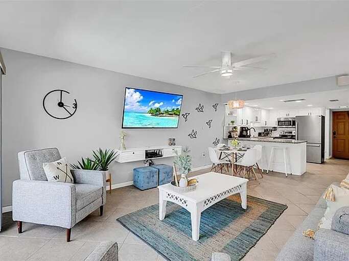 Kick back in this stylish, open-concept living area featuring a Smart TV, modern coastal decor, and a fully equipped kitchen—perfect for relaxing or entertaining after a day in the sun! Kick back in this stylish, open-concept living area featuring a Smart TV, modern coastal decor, and a fully equipped kitchen—perfect for relaxing or entertaining after a day in the sun!