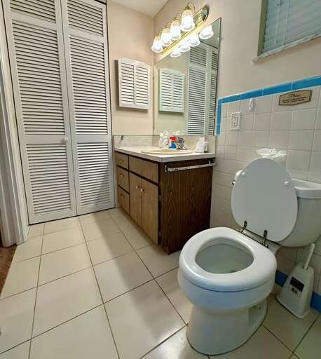 Clean and bright bathroom with a wide vanity, large mirror, and soft overhead lighting. Includes a Clean and bright bathroom with a wide vanity, large mirror, and soft overhead lighting. Includes a