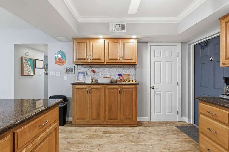 Enjoy a well-appointed beach condo kitchen featuring ample cabinetry, coastal décor, and plenty of