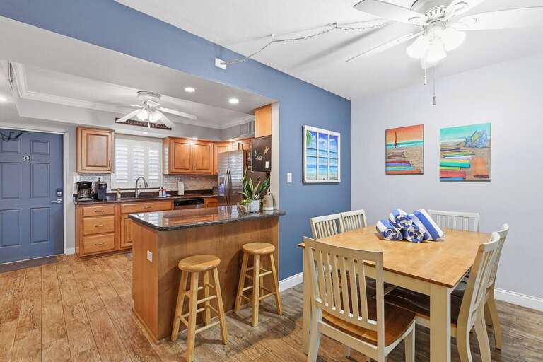 Enjoy meals and gatherings in this bright open-concept beach condo featuring a spacious dining area,