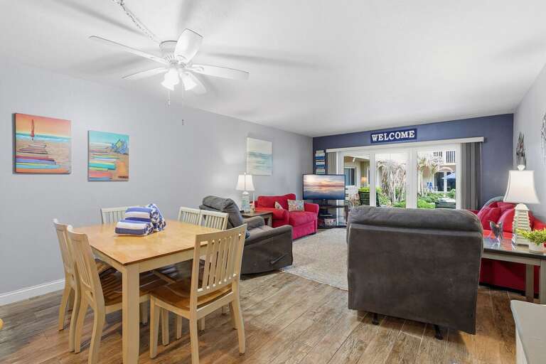 Gather and relax in this open beach condo featuring a cozy dining area, comfortable seating, and