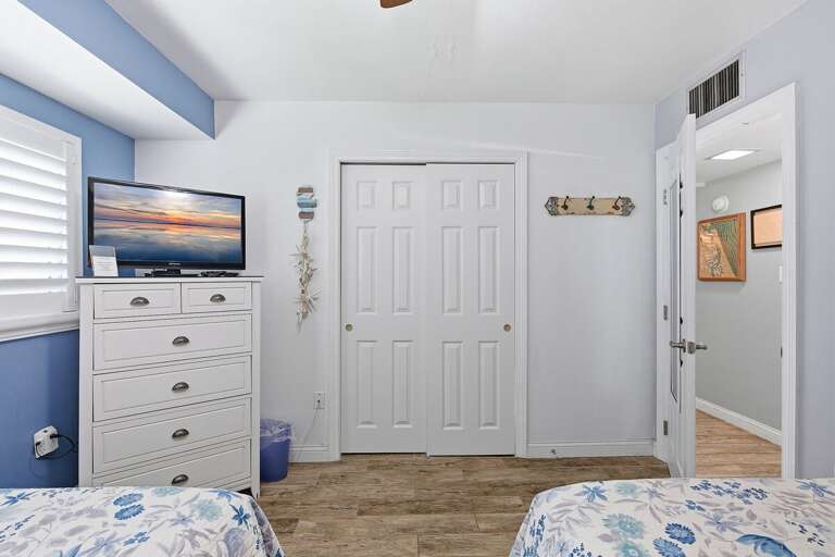 This inviting beach condo guest bedroom features coastal décor, comfortable beds, and a relaxing atmosphere perfect for family beach stays and restful nights after exploring the nearby shoreline.