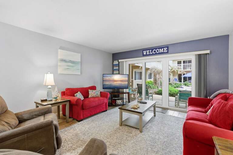 Relax in this comfortable beach condo living room featuring cozy seating, coastal décor, and