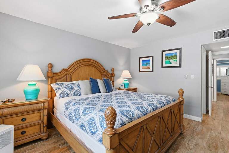 Relax in this inviting king bedroom featuring coastal décor, comfortable furnishings, and a peaceful atmosphere. Perfect for restful beach stays and unwinding after sunny days along the coast.