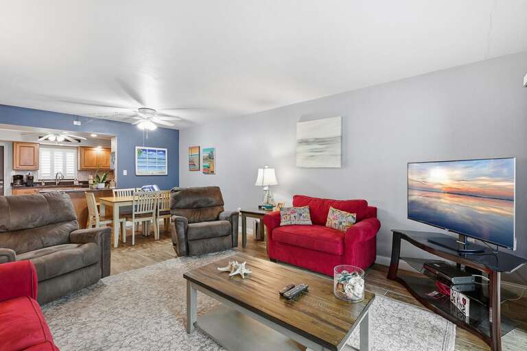 Relax in this spacious beach condo featuring comfortable seating, coastal décor, and an