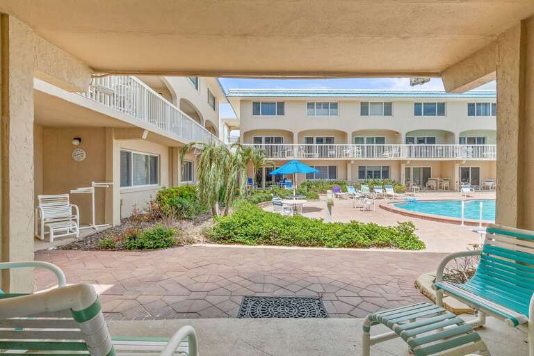 Step outside to this inviting poolside patio with comfortable seating and easy access to the resort-style pool. A relaxing beach stay perfect for enjoying coastal sunshine and seaside comfort.