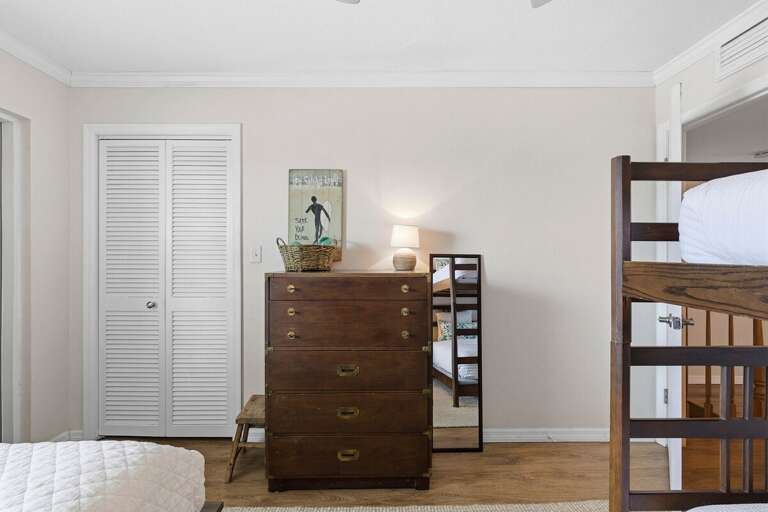 This cozy coastal guest bedroom features built-in bunk beds, beach-inspired décor, and plenty of space for families to relax after a fun-filled day at the beach. Perfect for your next beach stay.