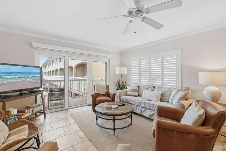 Enjoy a relaxing beach stay in this bright coastal living room featuring plush seating, beach-inspired décor, and private balcony access. The perfect space to unwind after a day by the ocean.