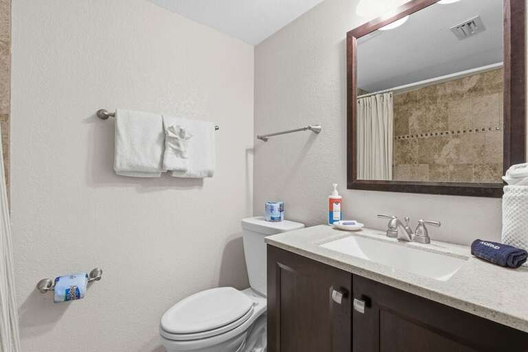 Freshen up in this updated coastal bathroom featuring modern finishes, a spacious vanity, and a clean, relaxing atmosphere. A comfortable beach stay with all the essentials for your seaside getaway.