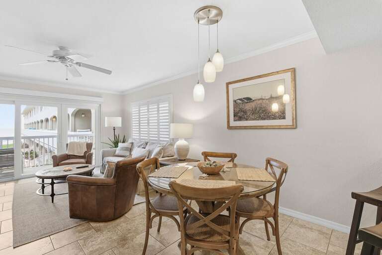 Gather for meals and unwind in this bright coastal living space featuring comfortable seating, a