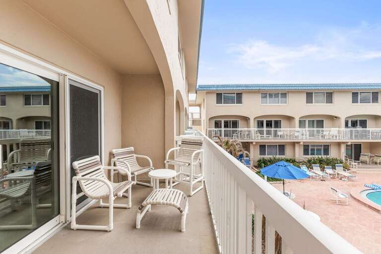 Relax on your private balcony with comfortable seating and views of the resort-style pool. This inviting beach stay offers the perfect spot to enjoy coastal breezes and unwind near the shore.
